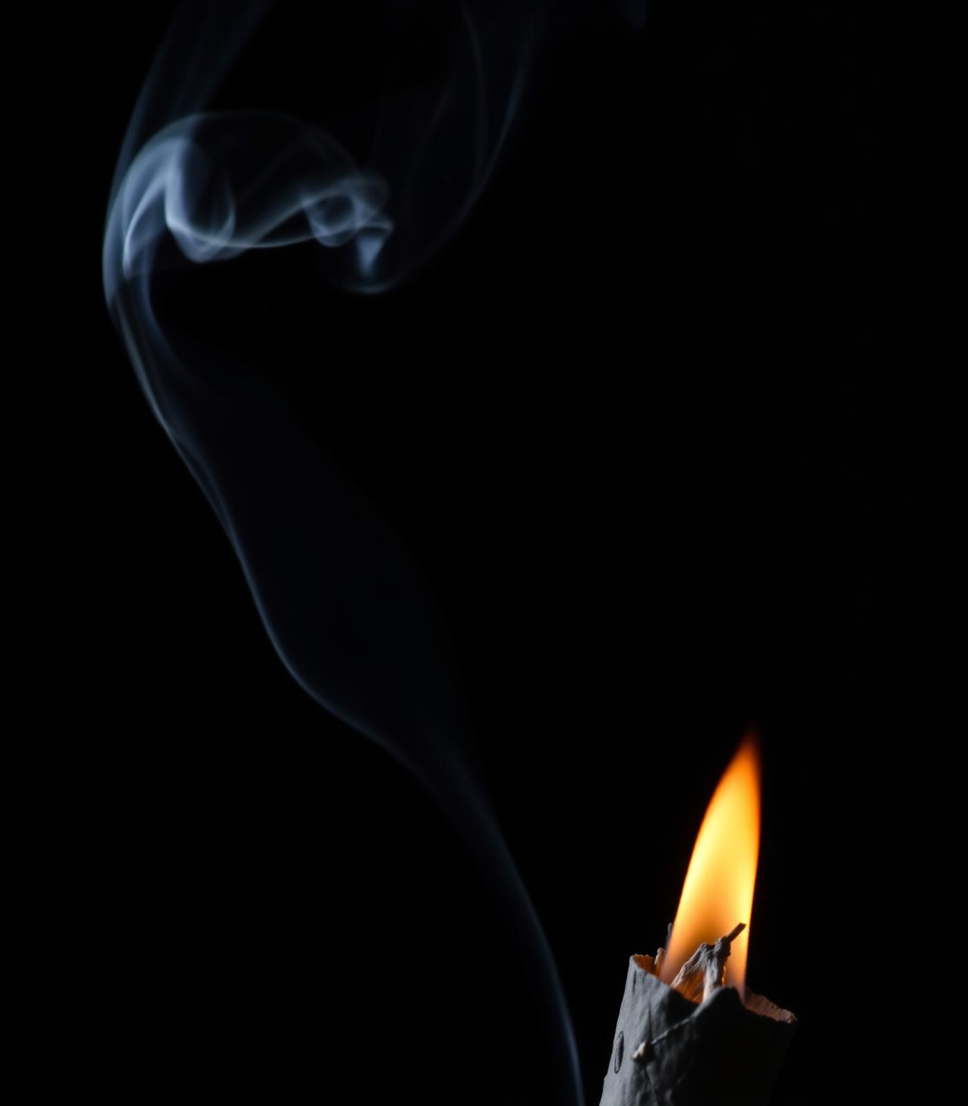 Sage smoke curling in the dark